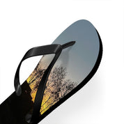 Flip-flop with sunset sky and tree branch design on a white background.