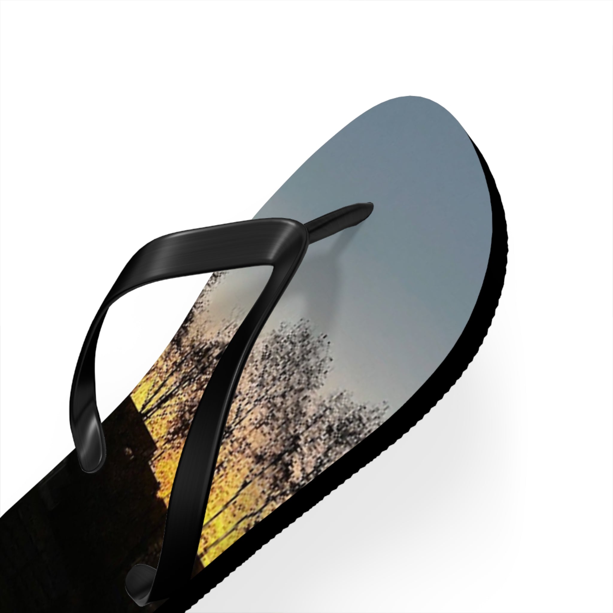Flip-flop with sunset sky and tree branch design on a white background.