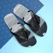 Black flip-flops with a snowy mountain landscape printed on the soles.