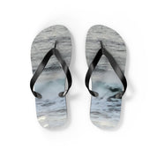 Flip-flops with wave pattern on straps and soles, isolated on white.