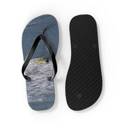 Flip-flops with ocean waves and a surfer on the left strap.
