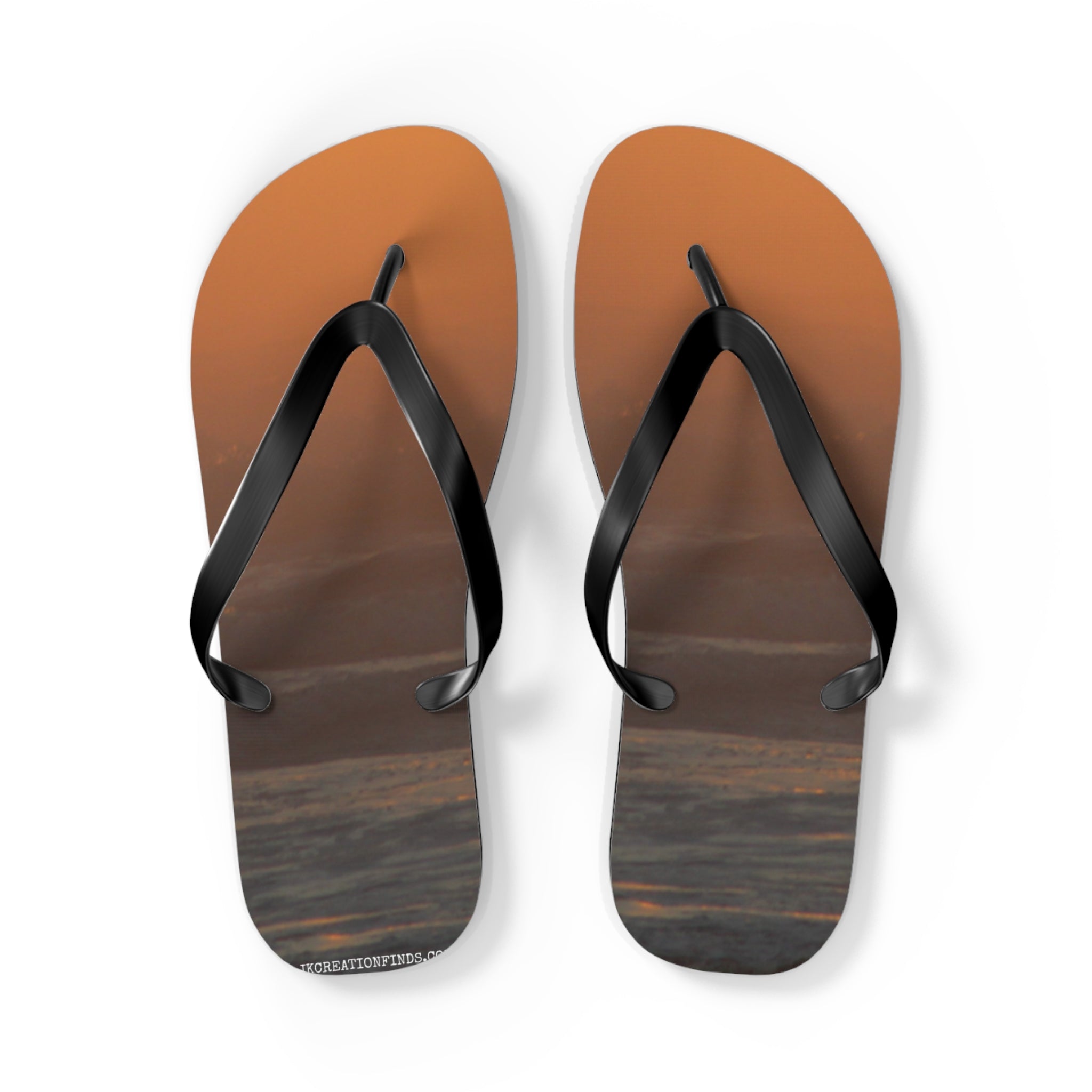 Flip-flops with a sunset ocean wave design on the soles.