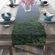 Table runner with a blurred forest and mountain scene.