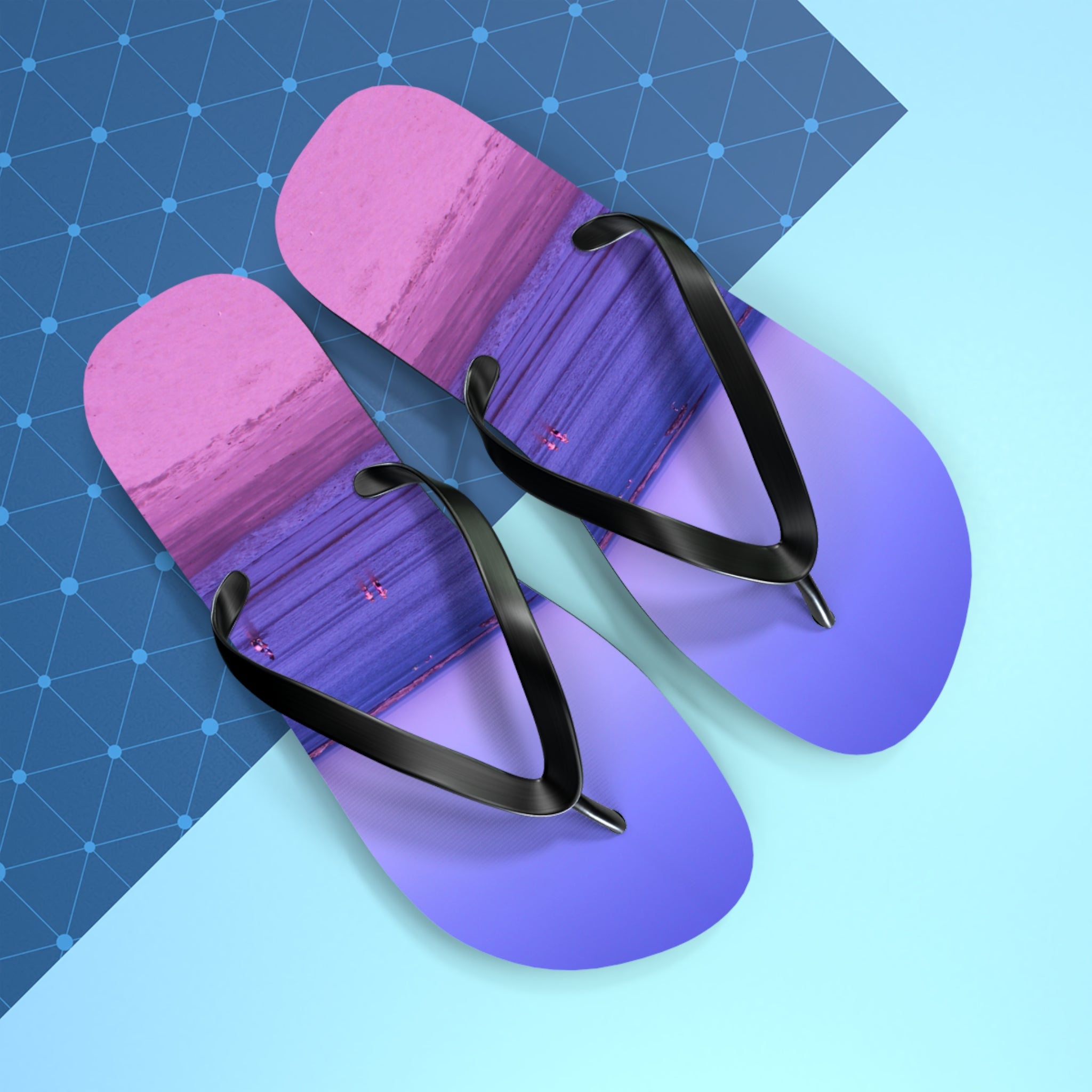 Purple and pink gradient flip-flops with black straps on a blue background.