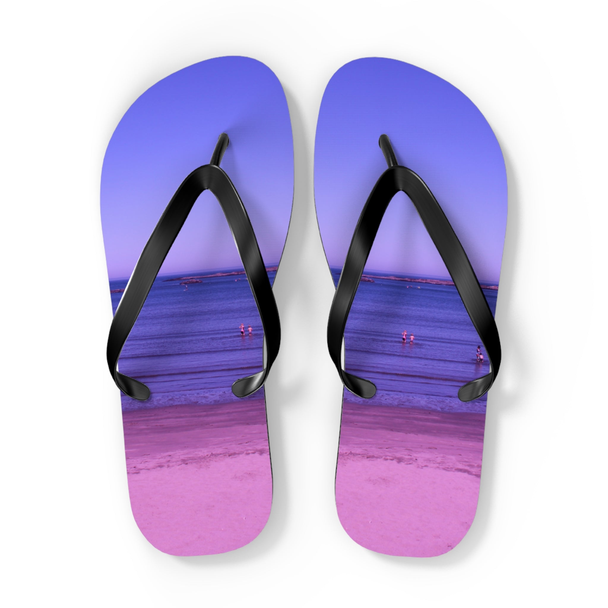Purple flip-flops with a beach scene printed on the soles.