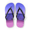 Purple flip-flops with a beach scene printed on the soles.