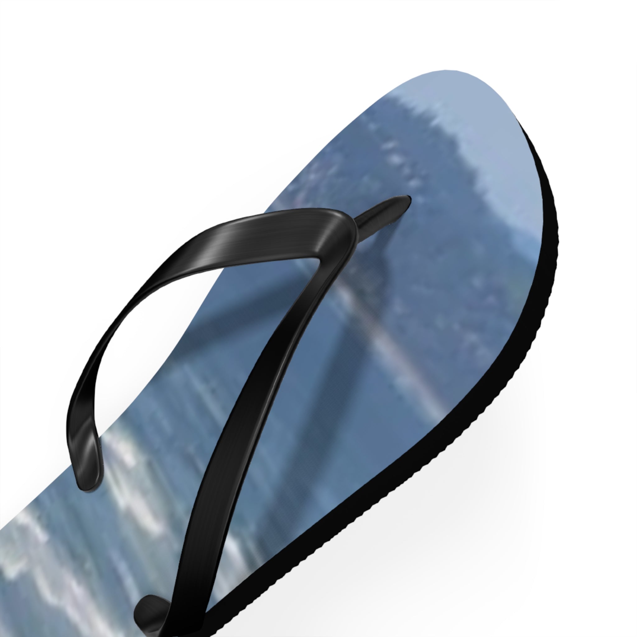 Black and blue flip-flop with a landscape scene on the sole.