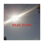 Bright solar eclipse with text and crescent moon.