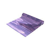 Rolled yoga mat with purple landscape design and "JKOREATRON.COM" text.