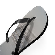 Black flip-flop with textured sole on white background.