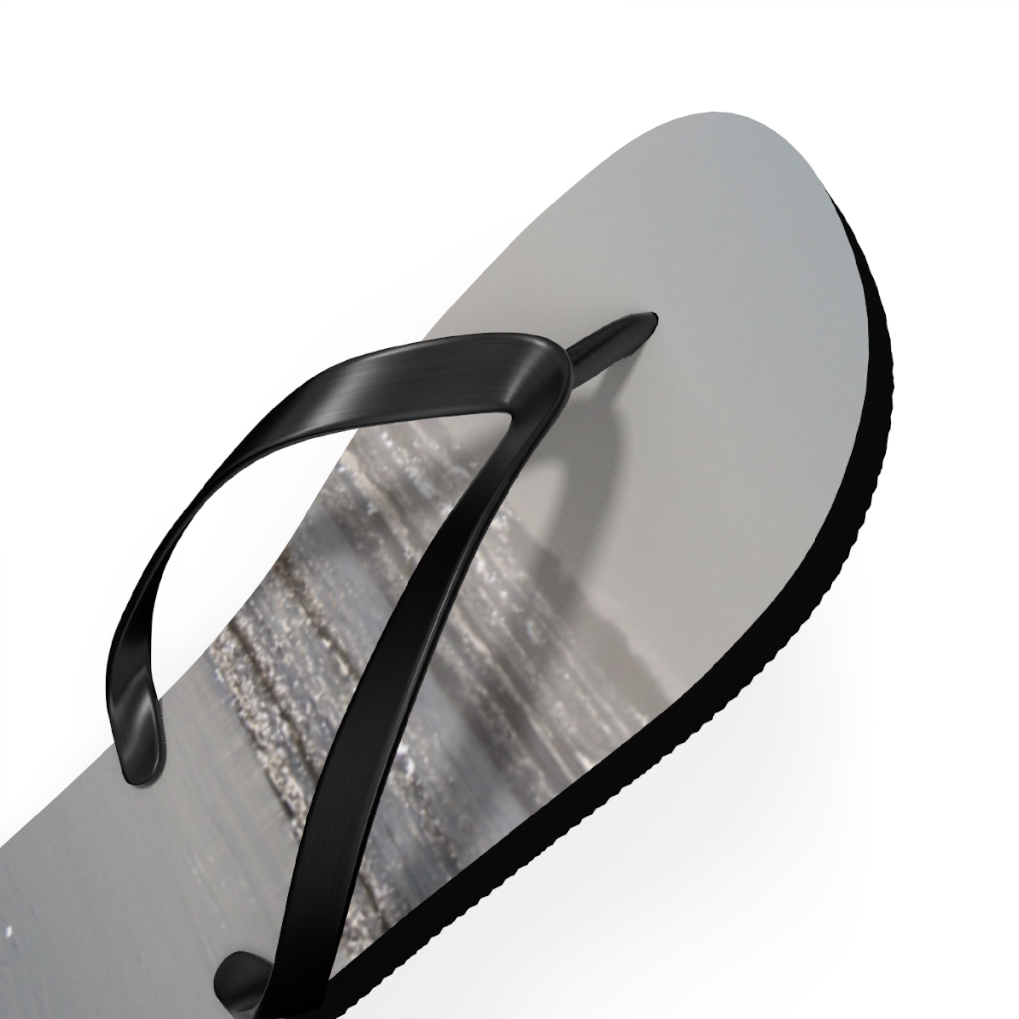 Black flip-flop with textured sole on white background.