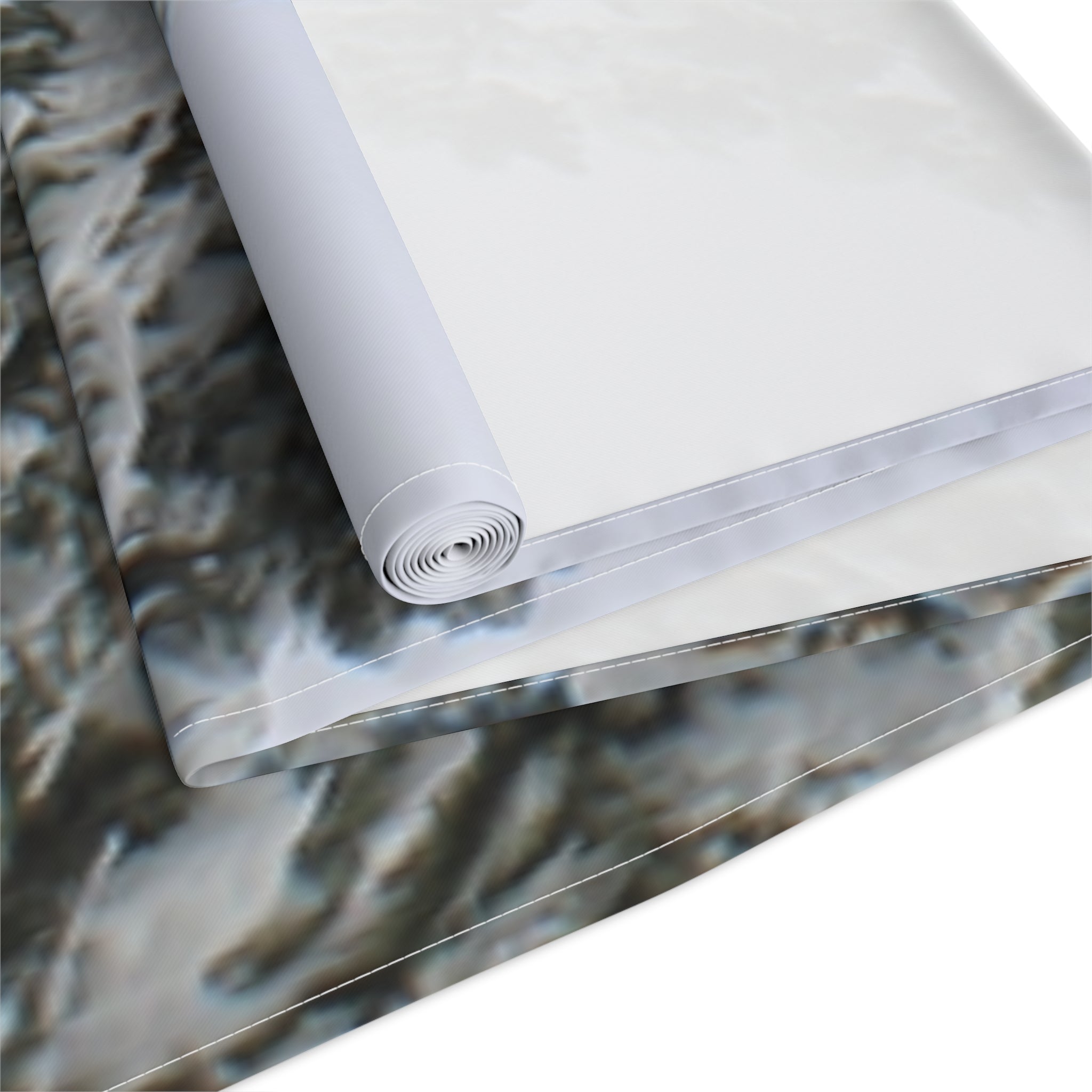Rolled fabric featuring a blurred mountain landscape pattern.