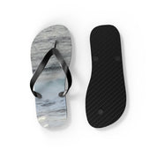 Flip-flops with a wave pattern on the sole and black straps.