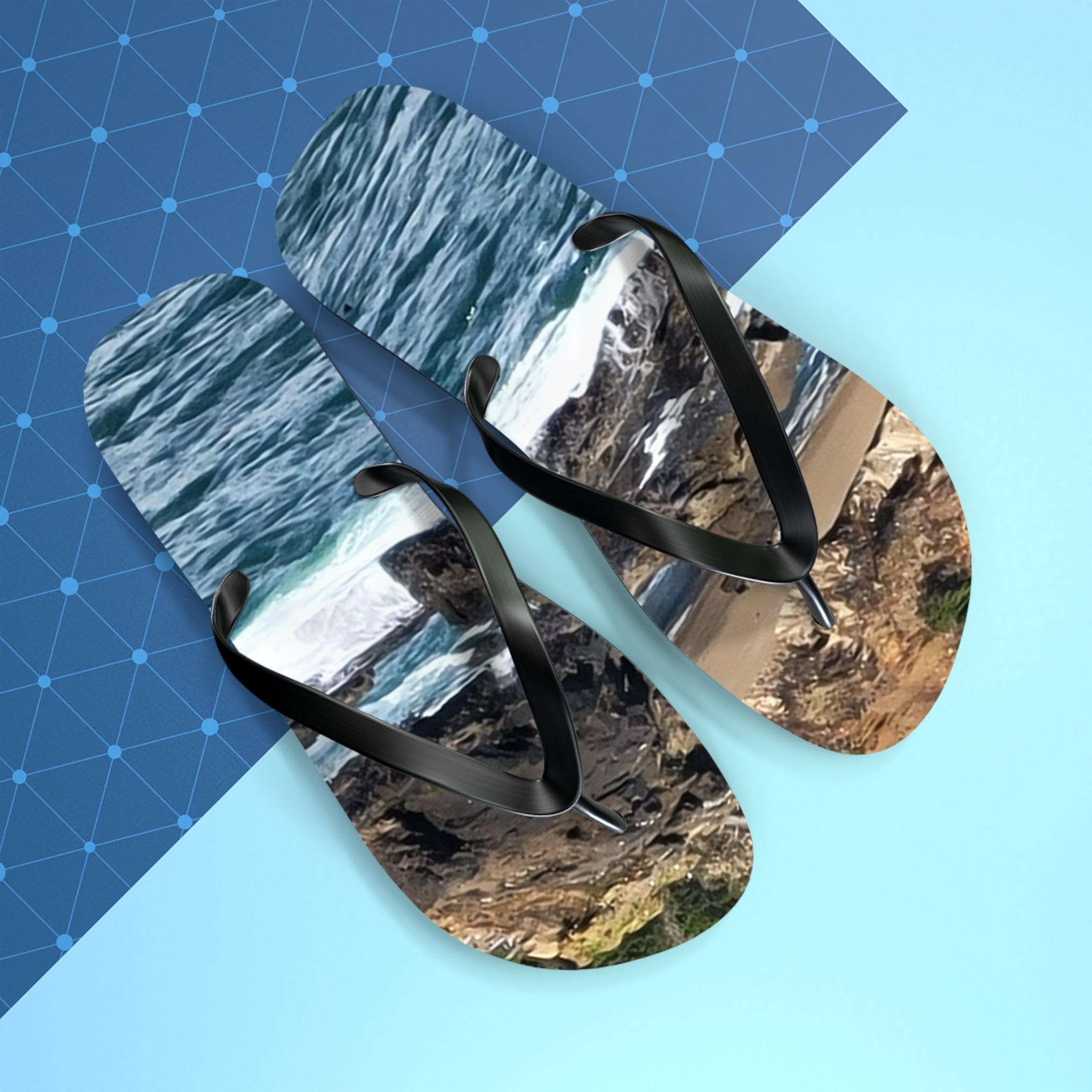 Flip-flops with a coastal landscape design on blue and gray background.