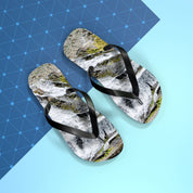 Flip-flops with waterfall print on a blue geometric background.