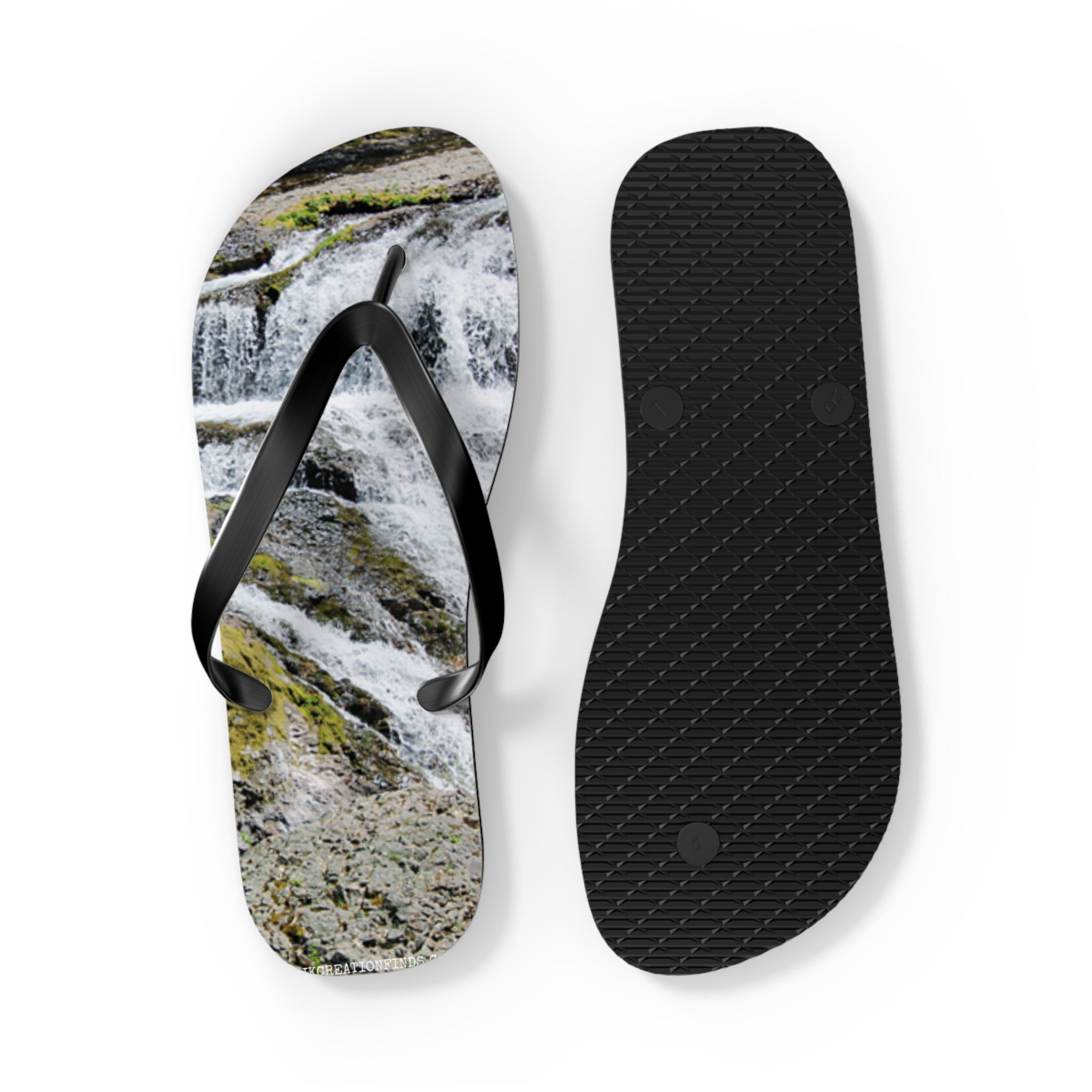 Flip-flops with waterfall scene print and black textured sole.