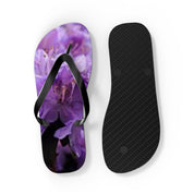 Purple floral flip-flops on a white background.