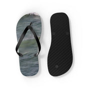 Flip-flops with ocean wave pattern on one sole, black rubber sole on the other.
