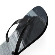 Black flip-flop sandal with a grey, rocky landscape printed on the sole.