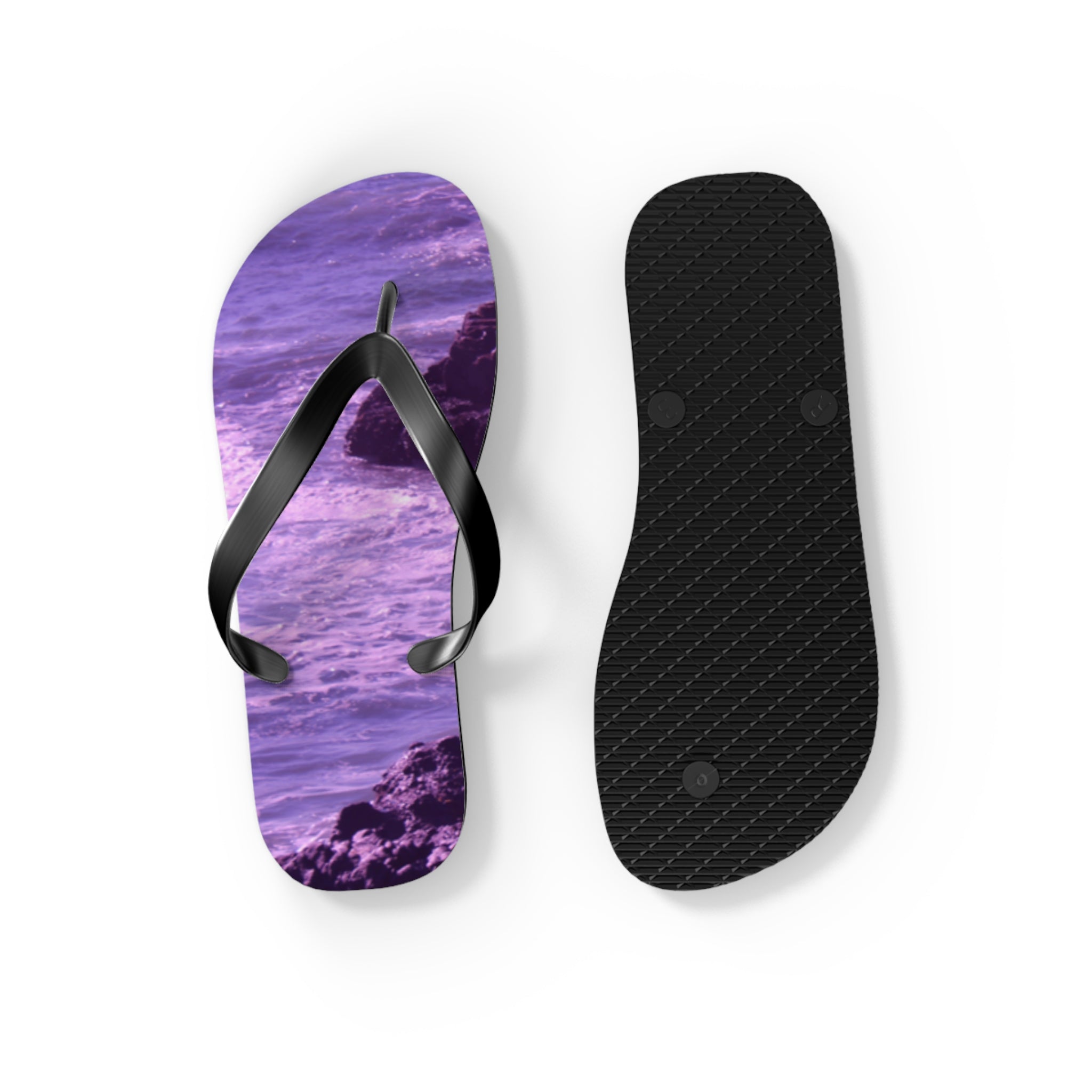 Purple ocean wave flip-flop and black sole on white background.