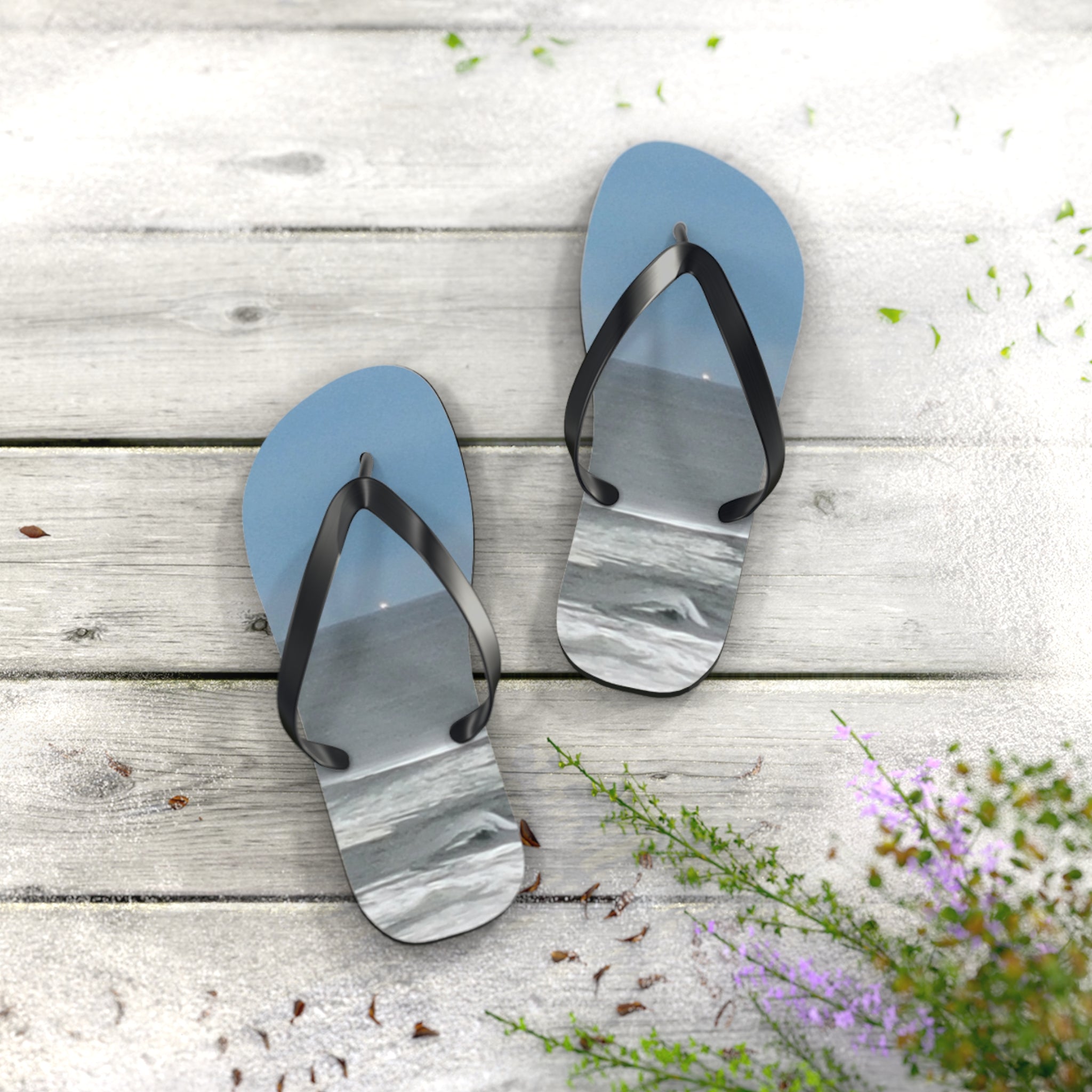 Blue flip-flops with a marble-like pattern on a wooden surface.