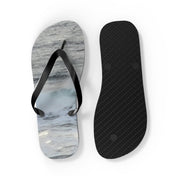 Flip-flops with ocean wave pattern and textured black sole.