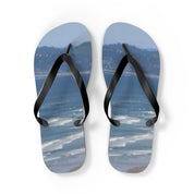 Flip flops with a beach and ocean scene on the soles.