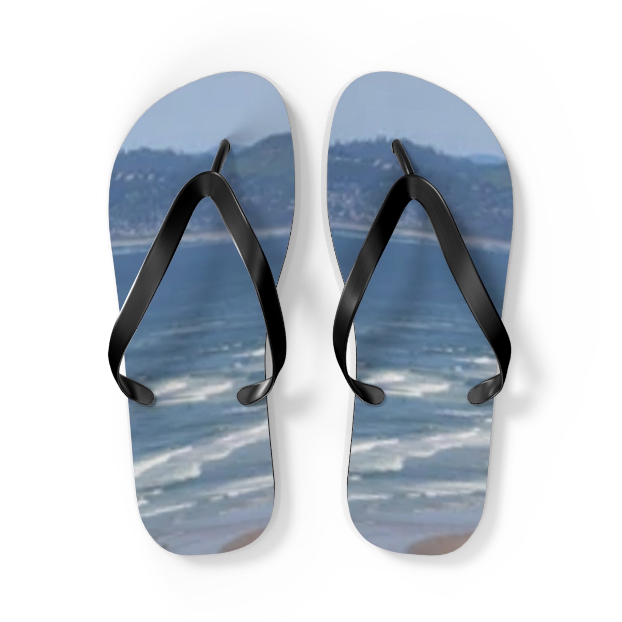 Flip flops with a beach and ocean scene on the soles.