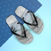 Flip-flops with marble pattern on black straps on blue and white background.