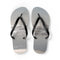 Flip-flops with a beach and ocean scene printed on the soles.