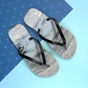 Pair of flip-flops with marbled grey and white soles and black straps.