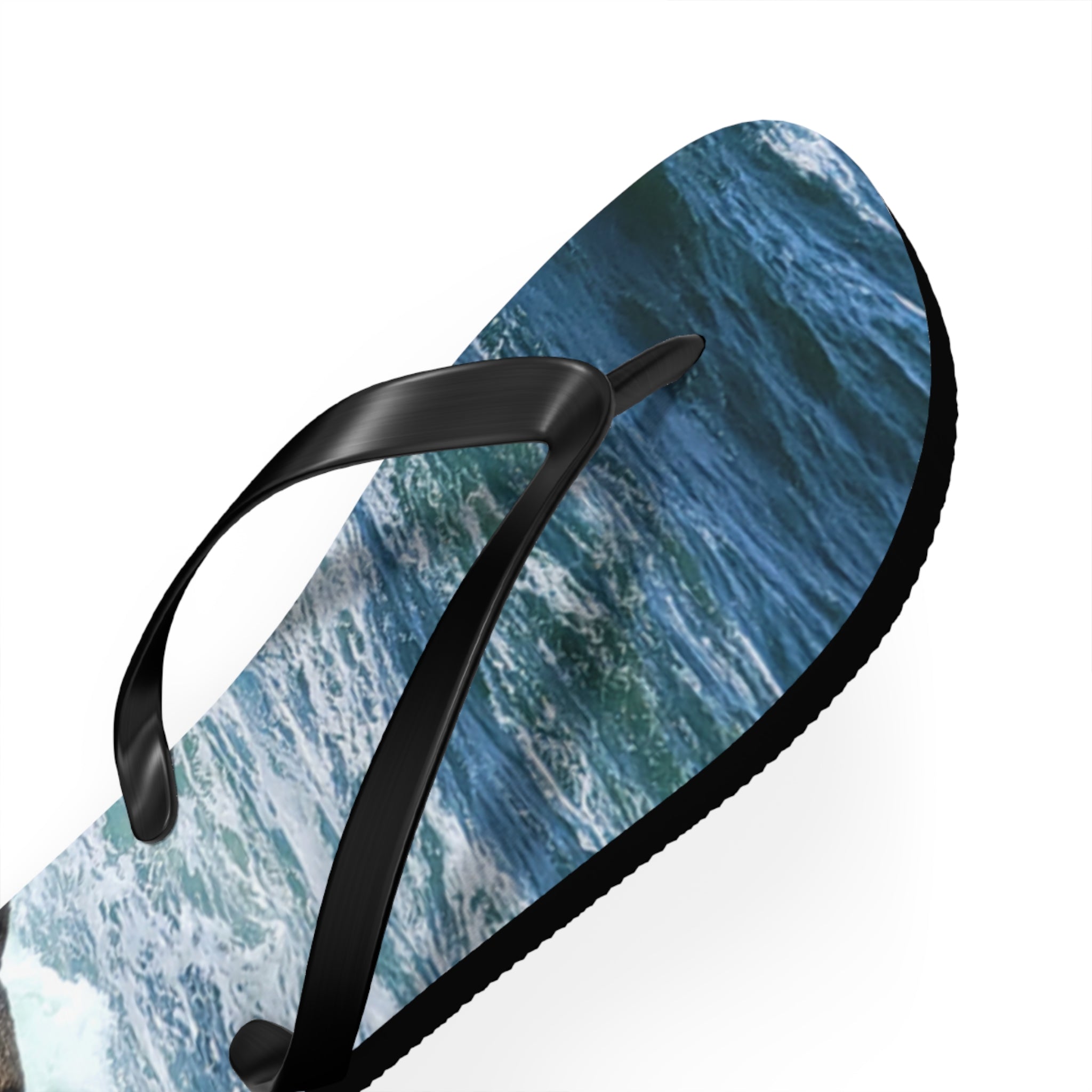 Black flip-flop with an ocean wave pattern on the sole.