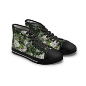 High-top canvas sneakers with a white floral pattern on black.