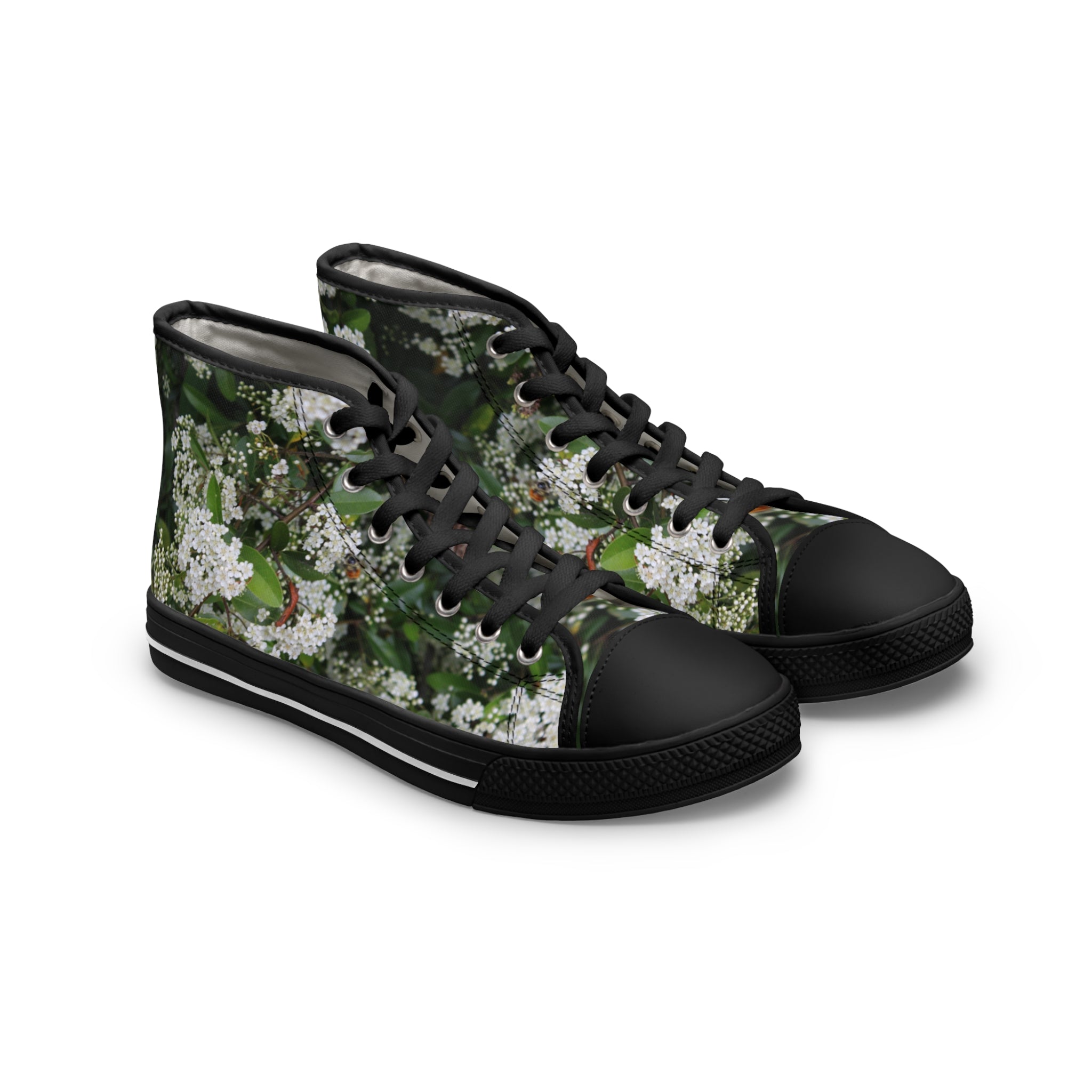 High-top canvas sneakers with a white floral pattern on black.
