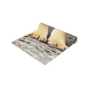 Close up of puppy paws on a textured surface, with a website URL visible.