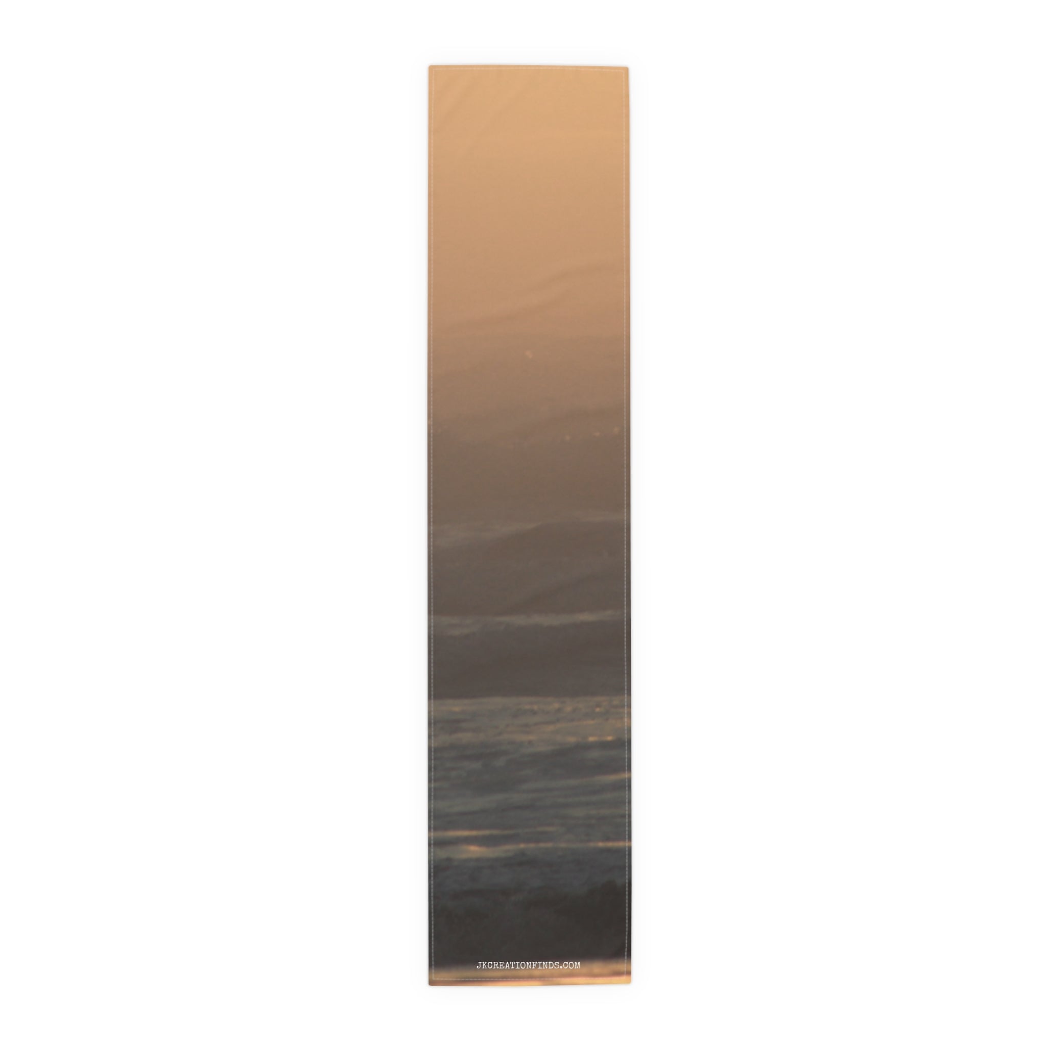 Abstract gradient sunset over ocean waves on a fabric banner.