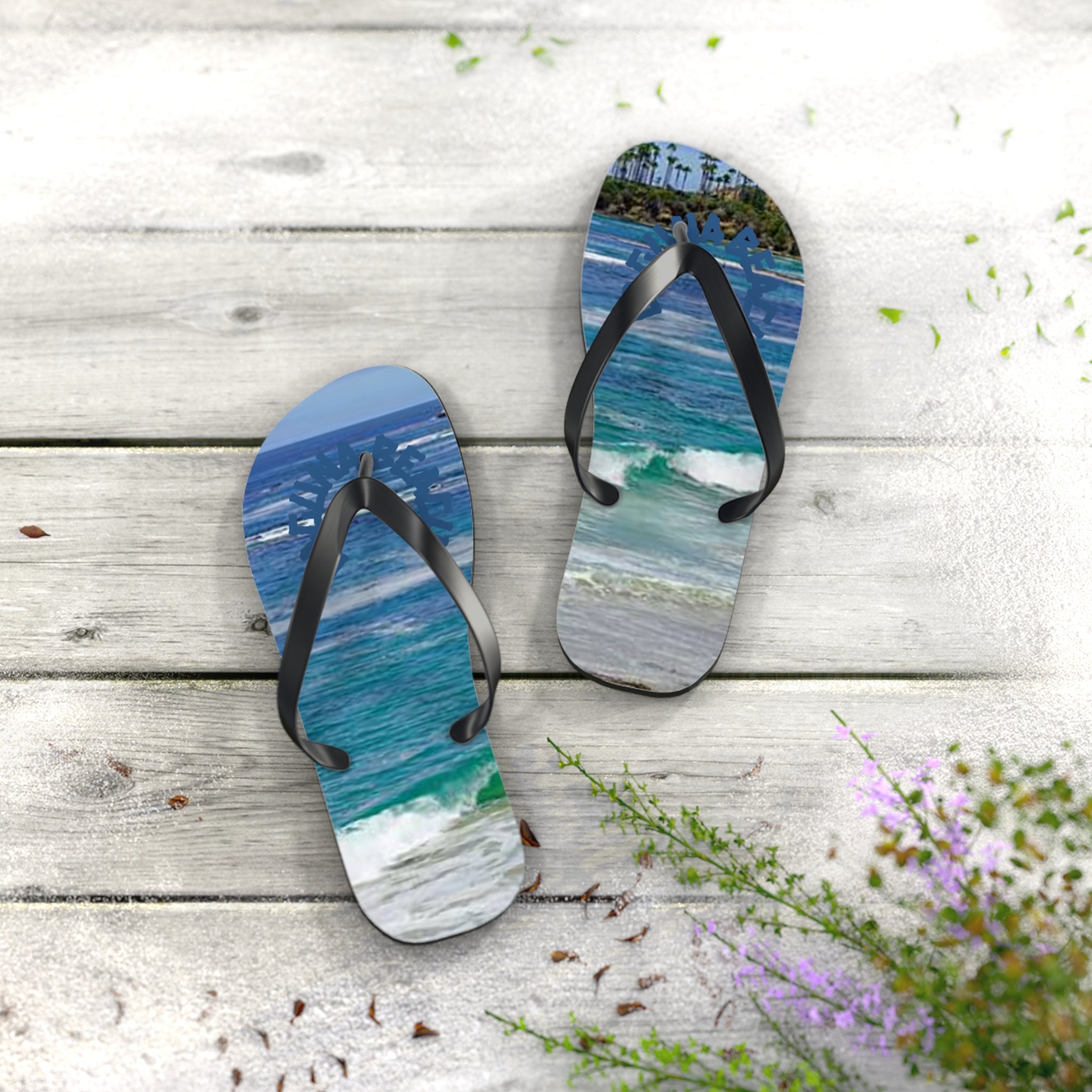 Flip-flops with ocean waves and beach scene on wooden planks.