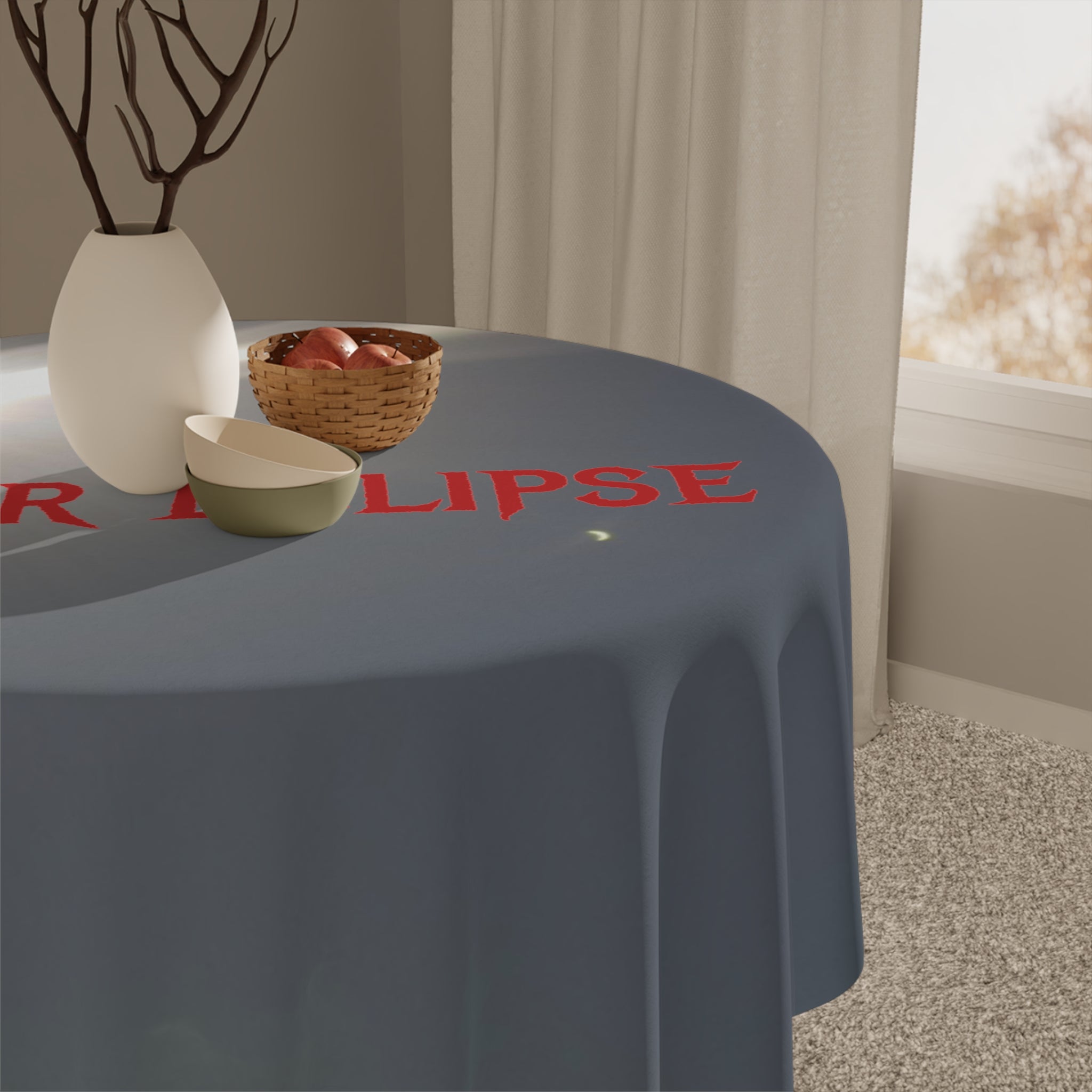Round tablecloth with red text reading "R" and "LIPSE" on a table.