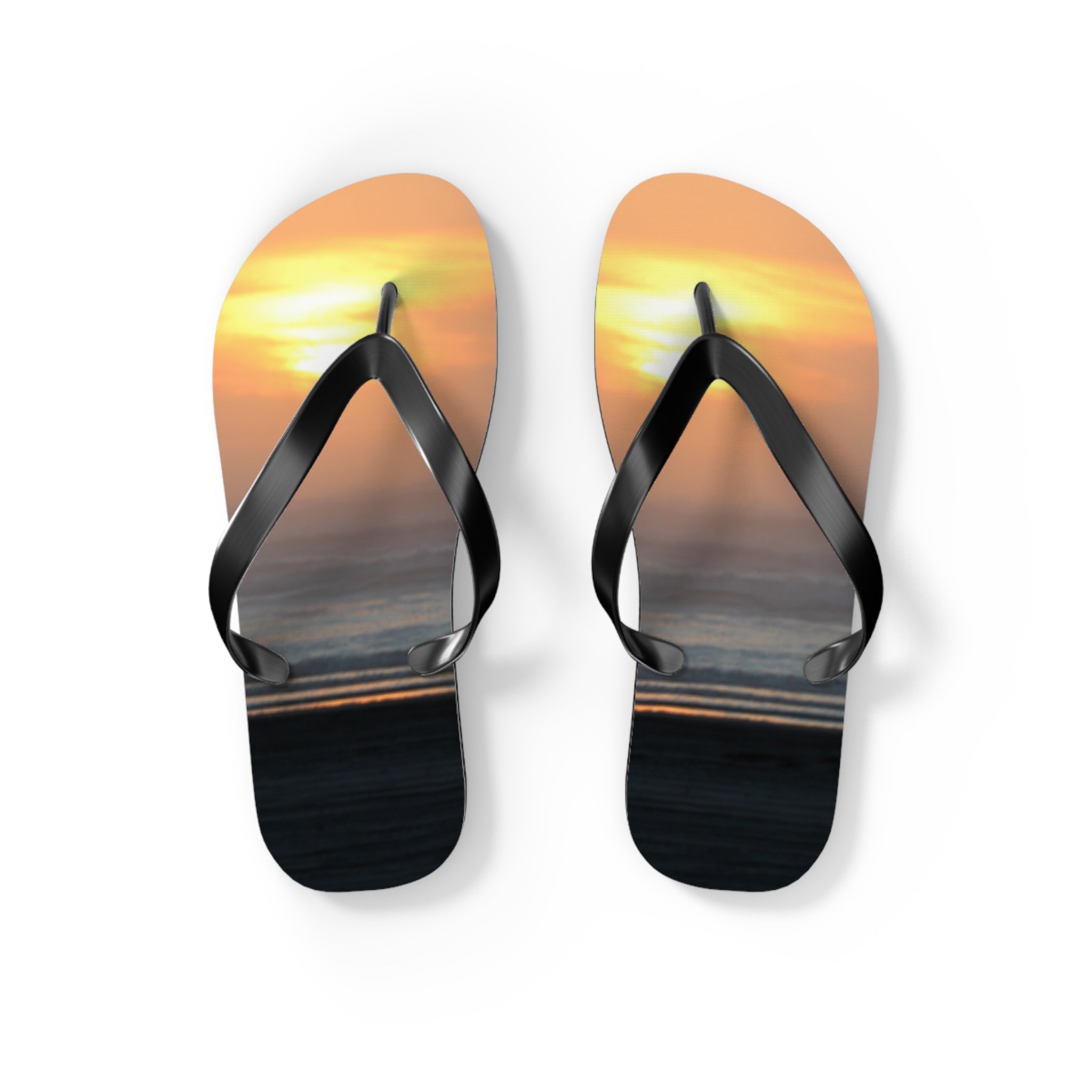 Flip-flops with a sunset ocean scene on the soles.