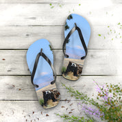 Flip flops featuring a scenic mountain view and rustic stone structure.
