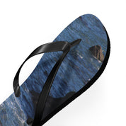 Black flip-flop with a close-up ocean wave pattern on the sole.