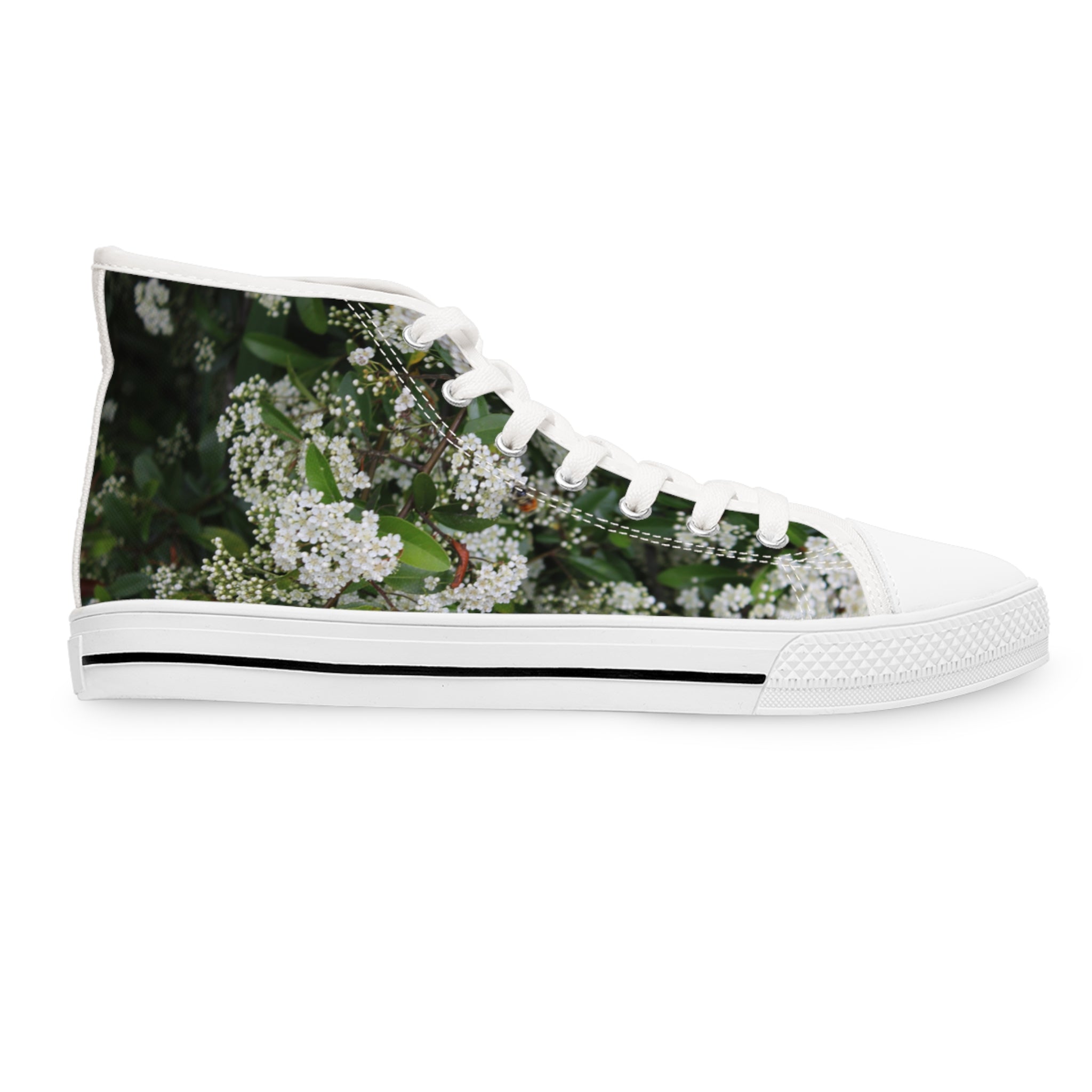 White high-top sneaker with a floral pattern of white blossoms and green leaves.
