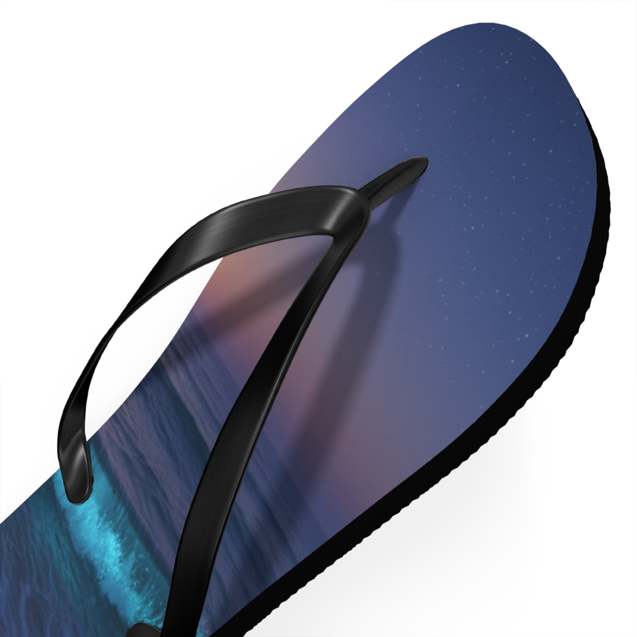 Flip-flop with ocean wave and starry night sky design.