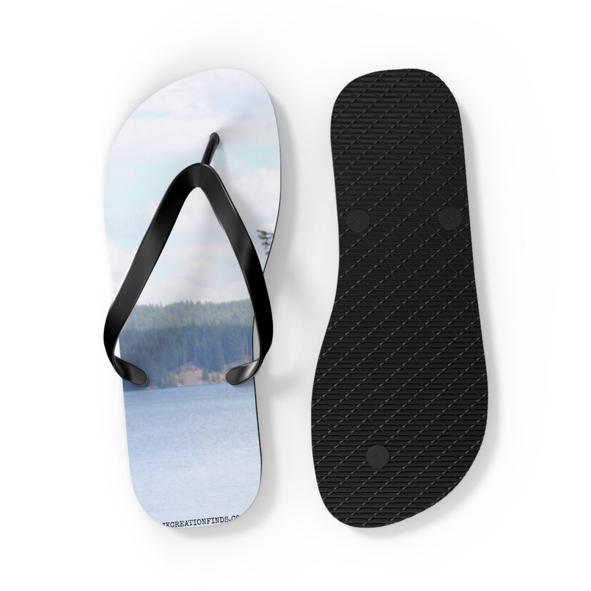 Flip-flops with a lake and forest scene on the left, black sole on the right.