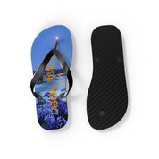 Flip-flops with "LAGUNA BEACH" text over a coastal nighttime scene.
