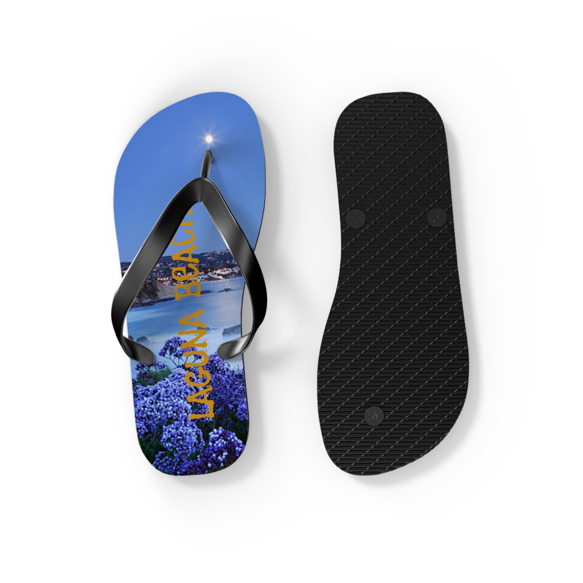 Flip-flops with "LAGUNA BEACH" text over a coastal nighttime scene.
