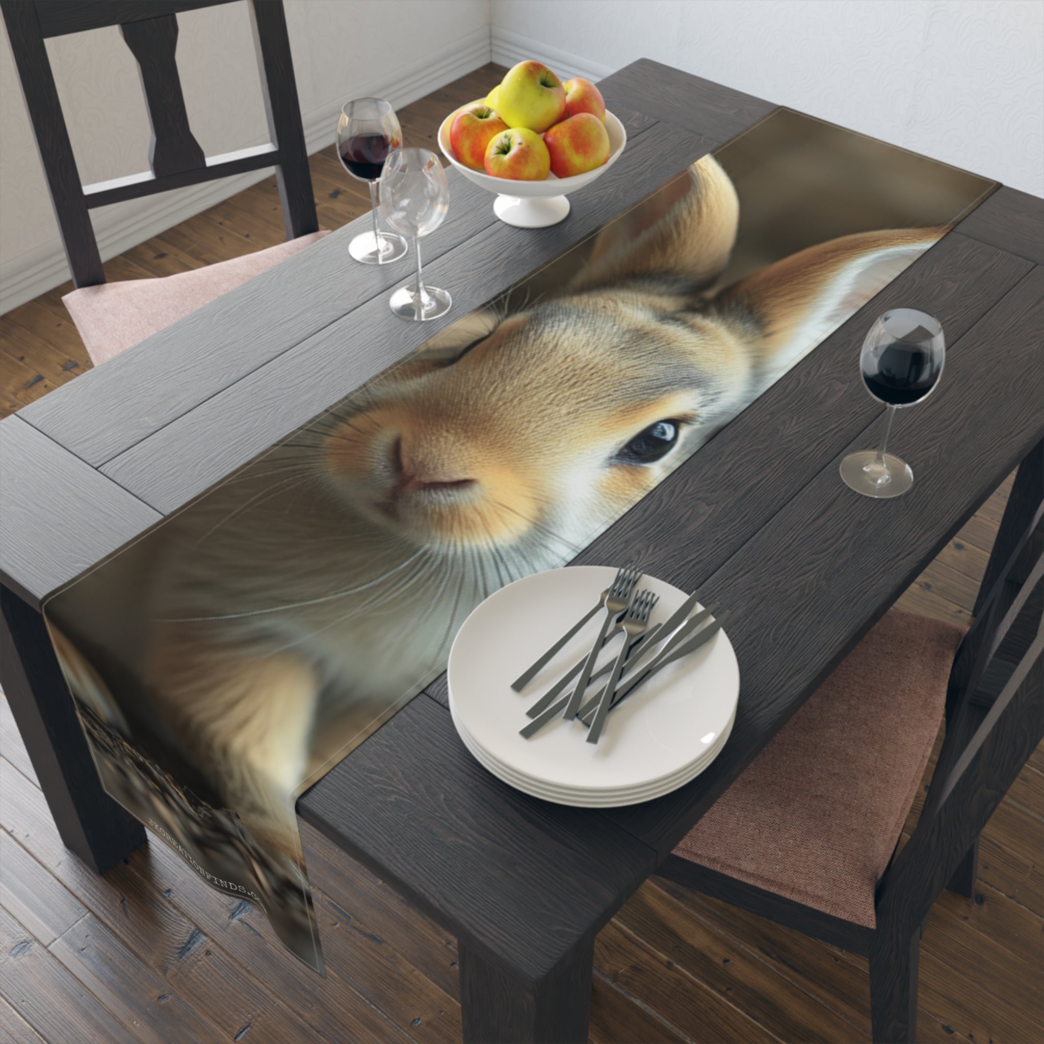 Close-up of a rabbit's face on a table runner with plates and cutlery.