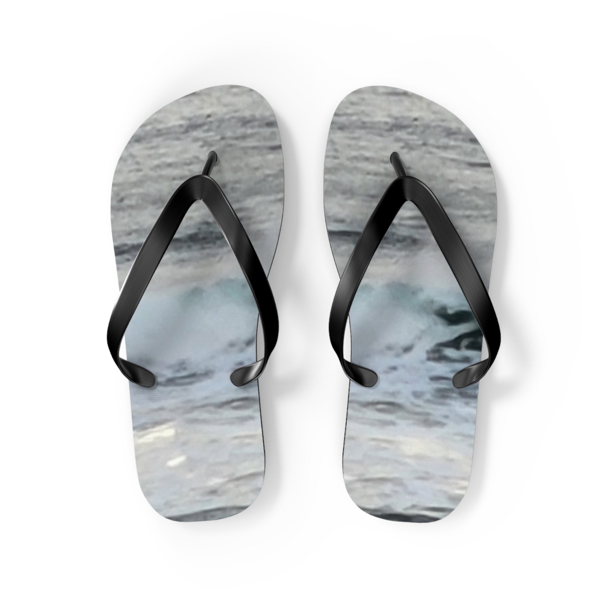 Pair of flip-flops with a realistic ocean wave design.