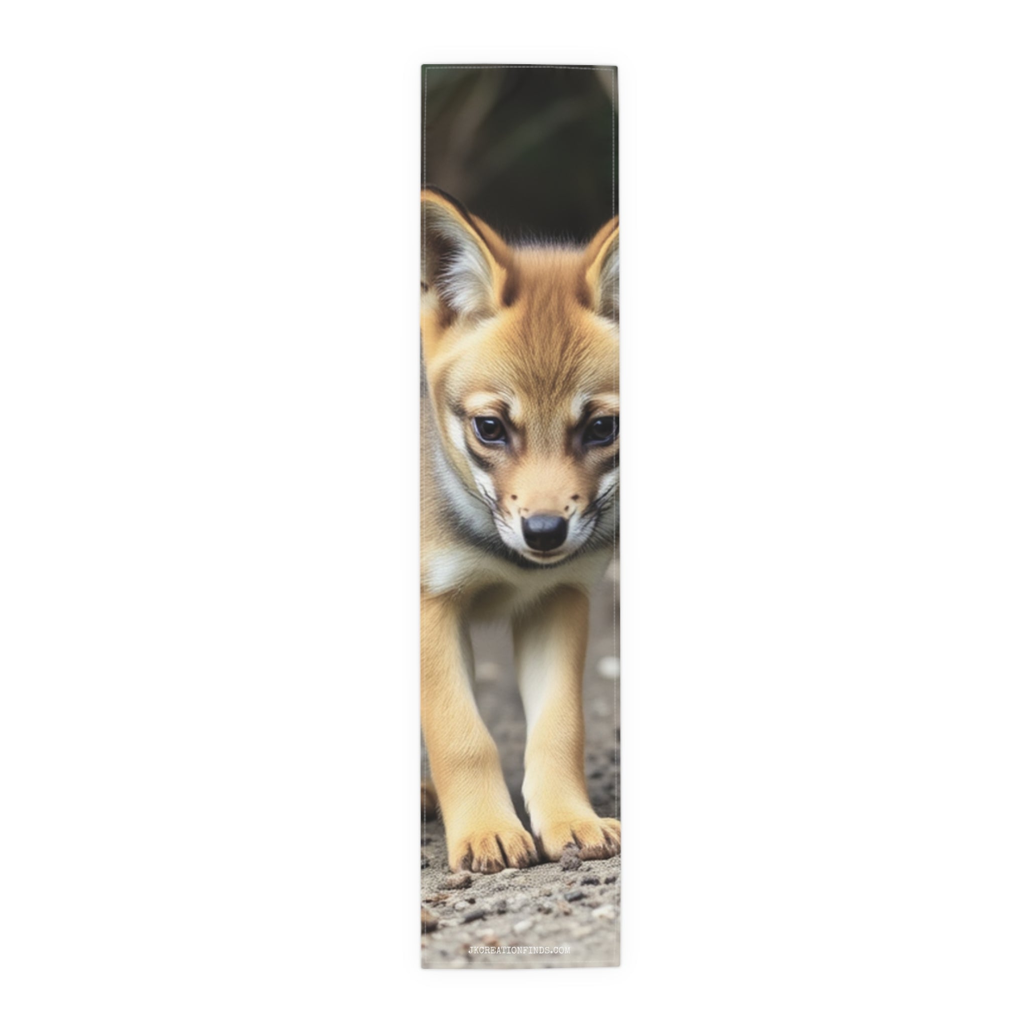 Close-up of a young fox looking down at the camera.