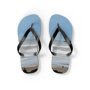 Flip-flops with a beach scene of people walking on the shore.
